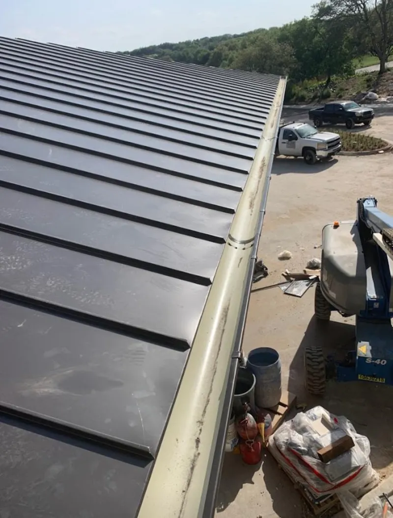 Standing seam panel and gutter detail on a metal roofing jobsite in High Point
